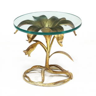 Arthur Court, Gilt Lily Side Table: Arthur Court, Gilt Lily Side Tablelate 20th century, circular glass top set on a cast and gilt aluminum base, unmarked. 16.75 x 19 in. diameter From the Collection of Gerard and Joanna Rattelade, Oxfo