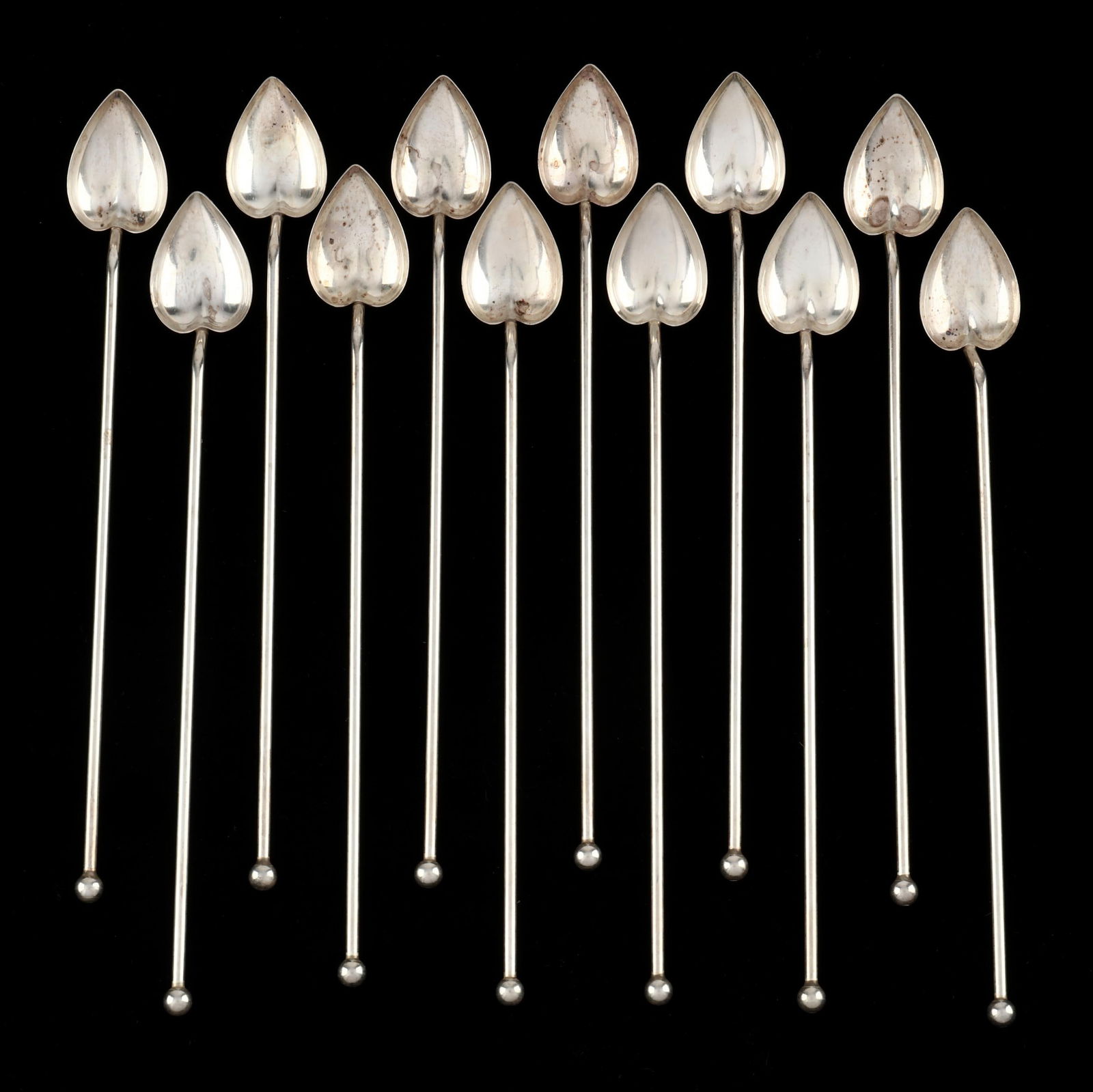 A Set of Twelve Sterling Silver Stirrer Straws: A Set of Twelve Sterling Silver Stirrer Strawsmark of Wallace Silversmiths, mid-20th century, hollow handles capped with a ball form finial and with heart form bowls. 8 1/4 in. 4.74 total troy oz. Ad