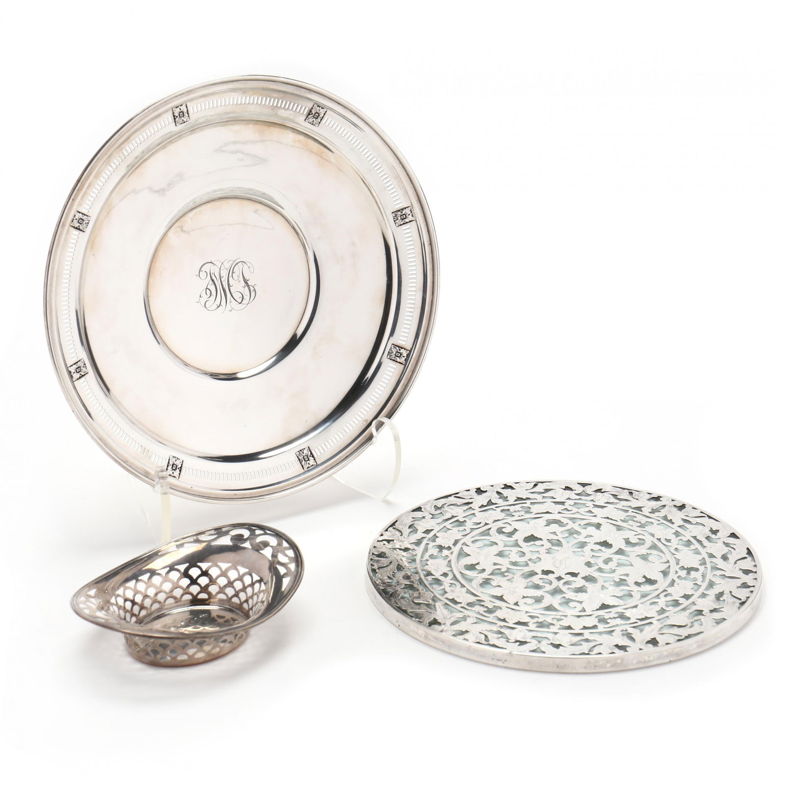 Group of Three Sterling Silver Hollowware Items: Group of Three Sterling Silver Hollowware Itemsincludes a Dominick & Haff pierced round footed tray (9 in. dia.), pattern number 3845; a Webster company overlaid trivet with chased floral design and g