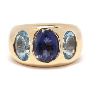 Gold and Gem-Set Ring, Andrew Clunn: Gold and Gem-Set Ring, Andrew Clunnthe tapered band centering on a flush set oval cut iolite weighing approximately 2.14 carats and with an oval cut aquamarine flush set to each side weighing approxim