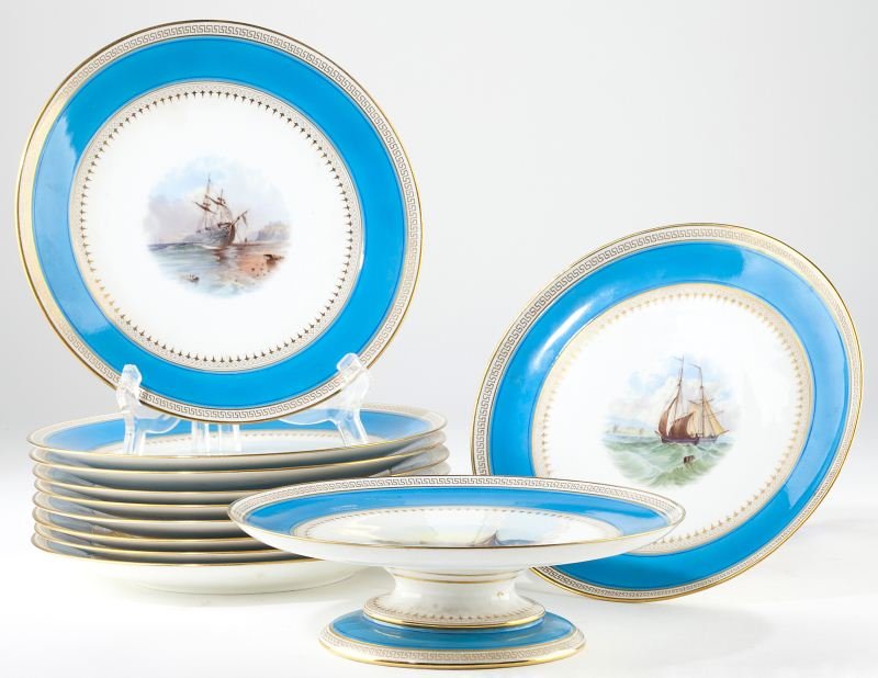 Mintons Porcelain Dessert Set: Mintons Porcelain Dessert Set (11) piece set including a pair of tazzas (2.75 x 9.25 in. diameter) and (9) plates (9.5 in. diameter). The two tazzas each feature a hand-painted scene with sailing ship
