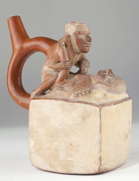 Pre-Columbian Style Mochica Fertility Vessel: Pre-Columbian Style Mochica Fertility Vessel Peru, possibly circa 300- 500 A. D., ceramic brown ware with creme and red-brown polychrome highlights, the cubic body surmounted by a copulating pair, the