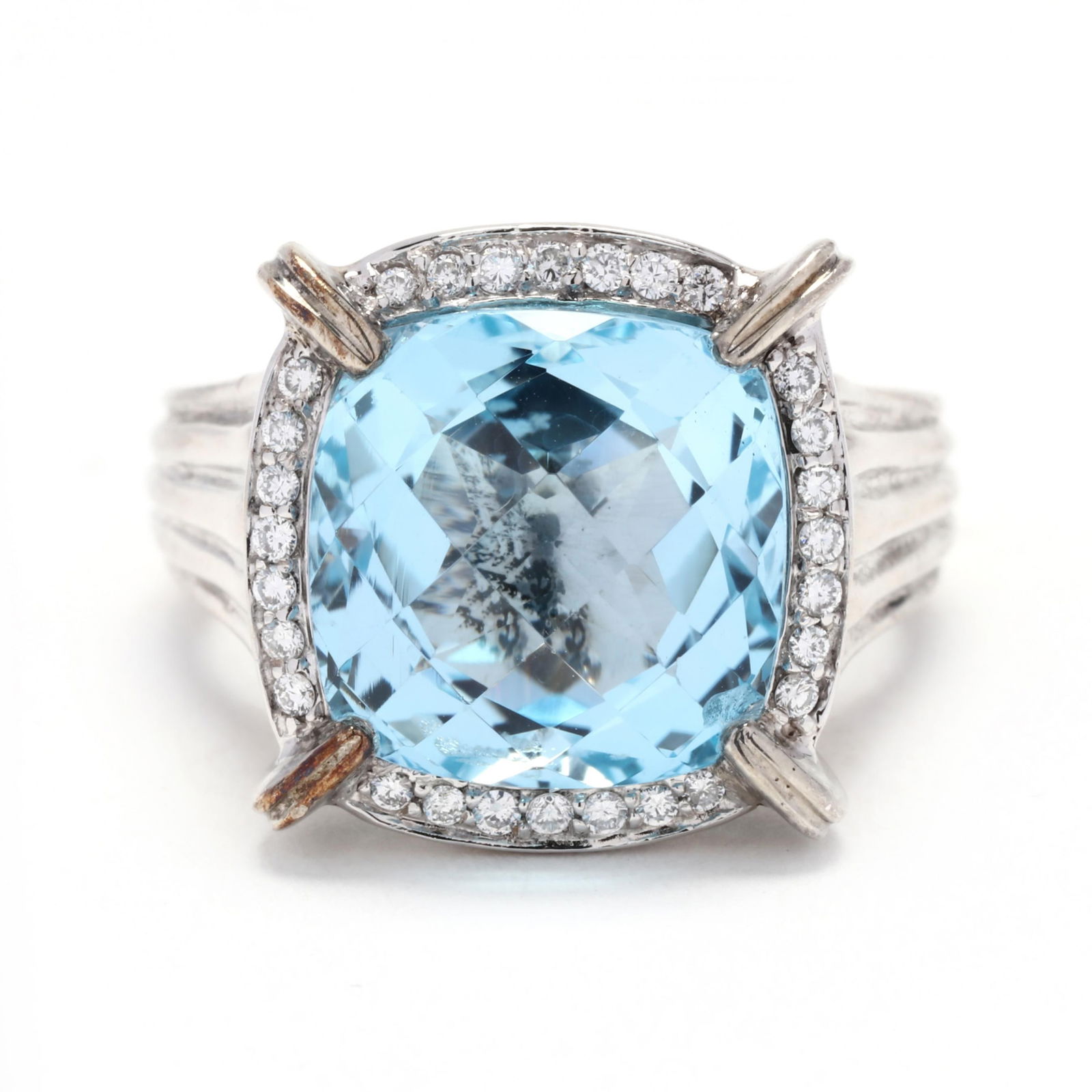 Gold, Silver, Topaz, and Diamond Ring, Charles Krypell: Gold, Silver, Topaz, and Diamond Ring, Charles Krypellcentered on a checkerboard cushion cut blue topaz weighing 9.91 carats, within a halo of full cut round diamonds weighing .20 total carat (H-I col