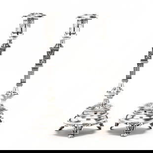 A Pair of Polish .800 Silver Repousse Candlesticks: A Pair of Polish .800 Silver Repousse Candlestickscirca 1920-1931 period mark, stamped "FiK", baluster form, foliate and neoclassical decoration in high relief on a stippled ground, raised on three sc