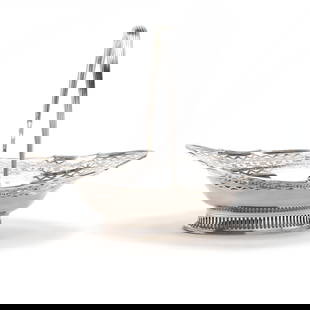 A Large George III Silver Cake Basket, Mark of Hester Bateman: A Large George III Silver Cake Basket, Mark of Hester BatemanLondon (1788) hallmarks, oval form with scalloped rim and decorative engraving and cutwork borders, raised on a pierced oval foot, and topp