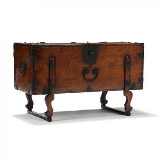 A Large Korean Chest: A Large Korean Chest Joseon dynasty (1392-1910), 19th century, elmwood chest on elegantly carved raised legs on wooden bands, shaped iron hardwood with heavy lockplate that lifts to open a large inter