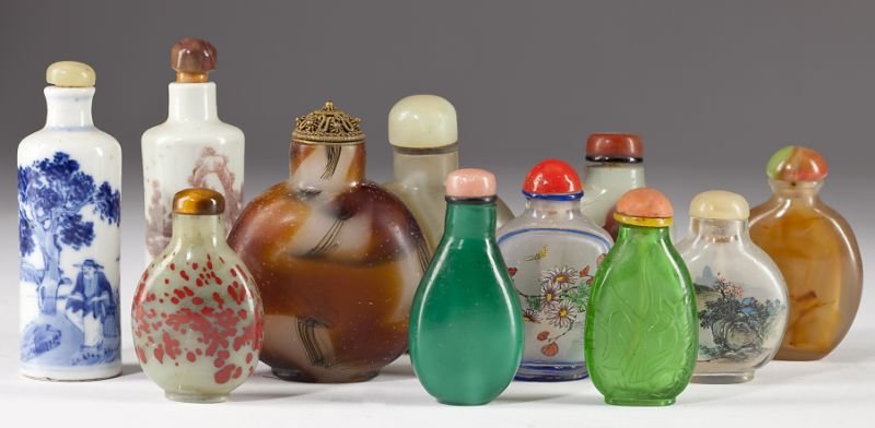 Eleven Chinese Snuff Bottles: Eleven Chinese Snuff Bottles 20th century, (2) porcelain; (5) hardstone; (4) glass. All are complete with spoons. 2 in. to 3.25 in. Collection of the late Robert N. Cook, Jr., Graham, NC