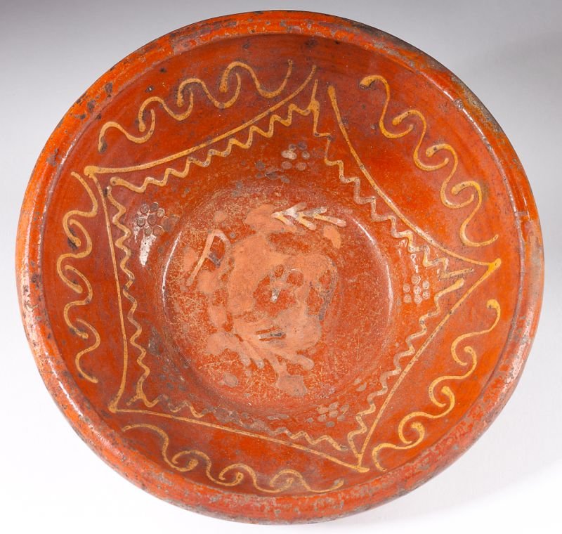 Redware Slip Decorated Mixing Bowl: Redware Slip Decorated Mixing BowlAmerican, 19th century, tapered form with interior slip decoration of swirls and zigzag bands, the center design, which may have included initials between stylized br
