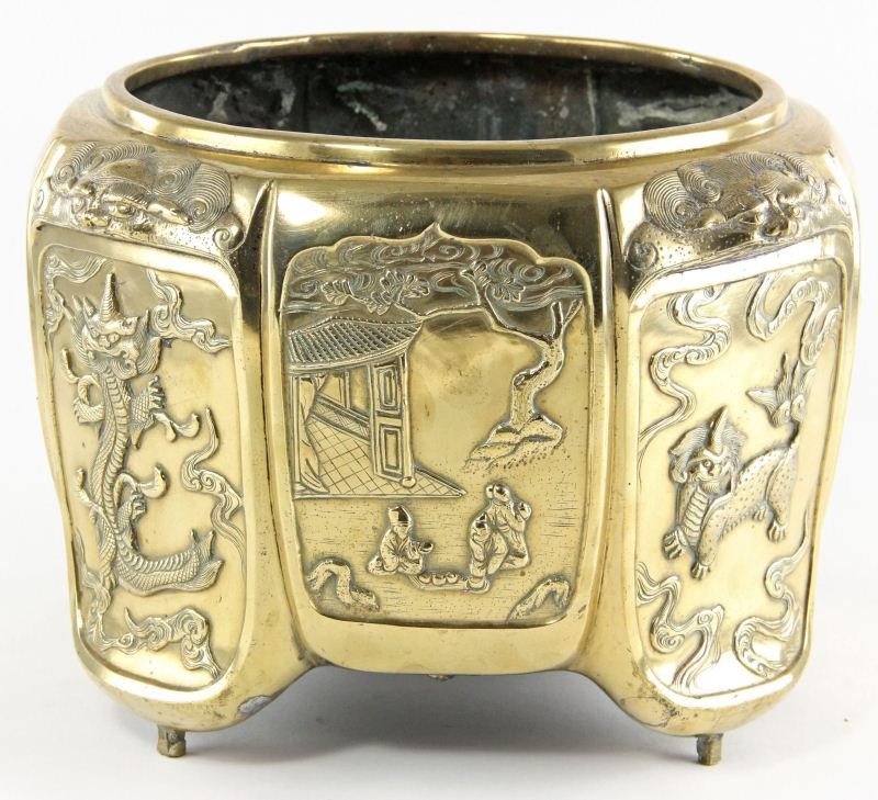 Asian Style Brass Jardinière: Asian Style Brass Jardinière faceted sides with scenes of foo dogs, figures, and dragons. 9 x 13 in. diameter