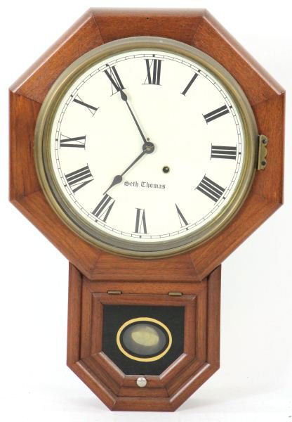Antique Seth Thomas Wall Clock: Antique Seth Thomas Wall Clockwalnut case, octagonal frame at top with lower drop featuring an eglomise lift lid cover over the pendulum with original paper label to interior, with key and pendulum.24
