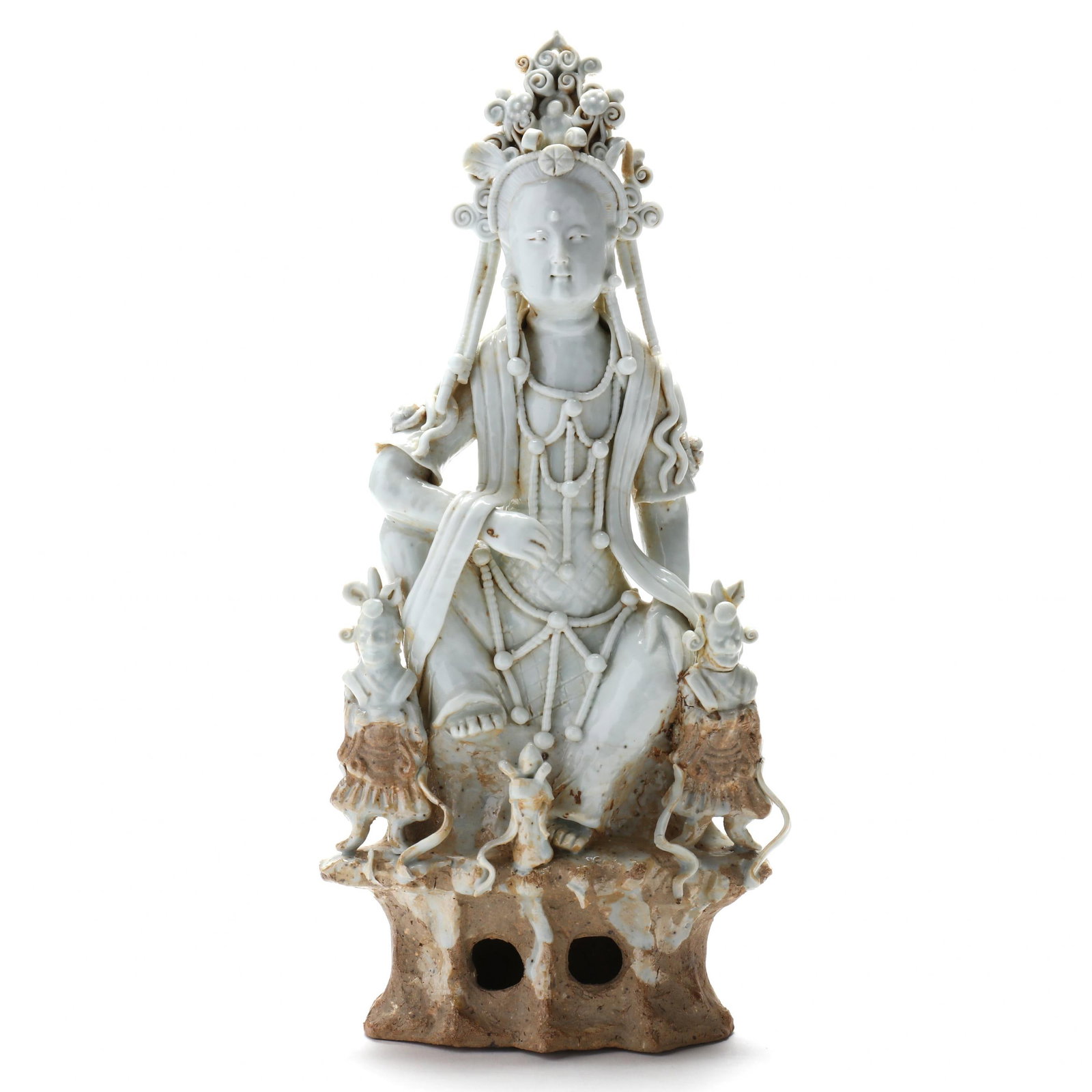 A Chinese Blanc de Chine Figure of Guanyin: A Chinese Blanc de Chine Figure of Guanyin Qing dynasty (1644–1911), the figure depicted seated atop a rocky base flanked by attendants, not marked. 11 1/2 in. From a Private Collection, Washington,