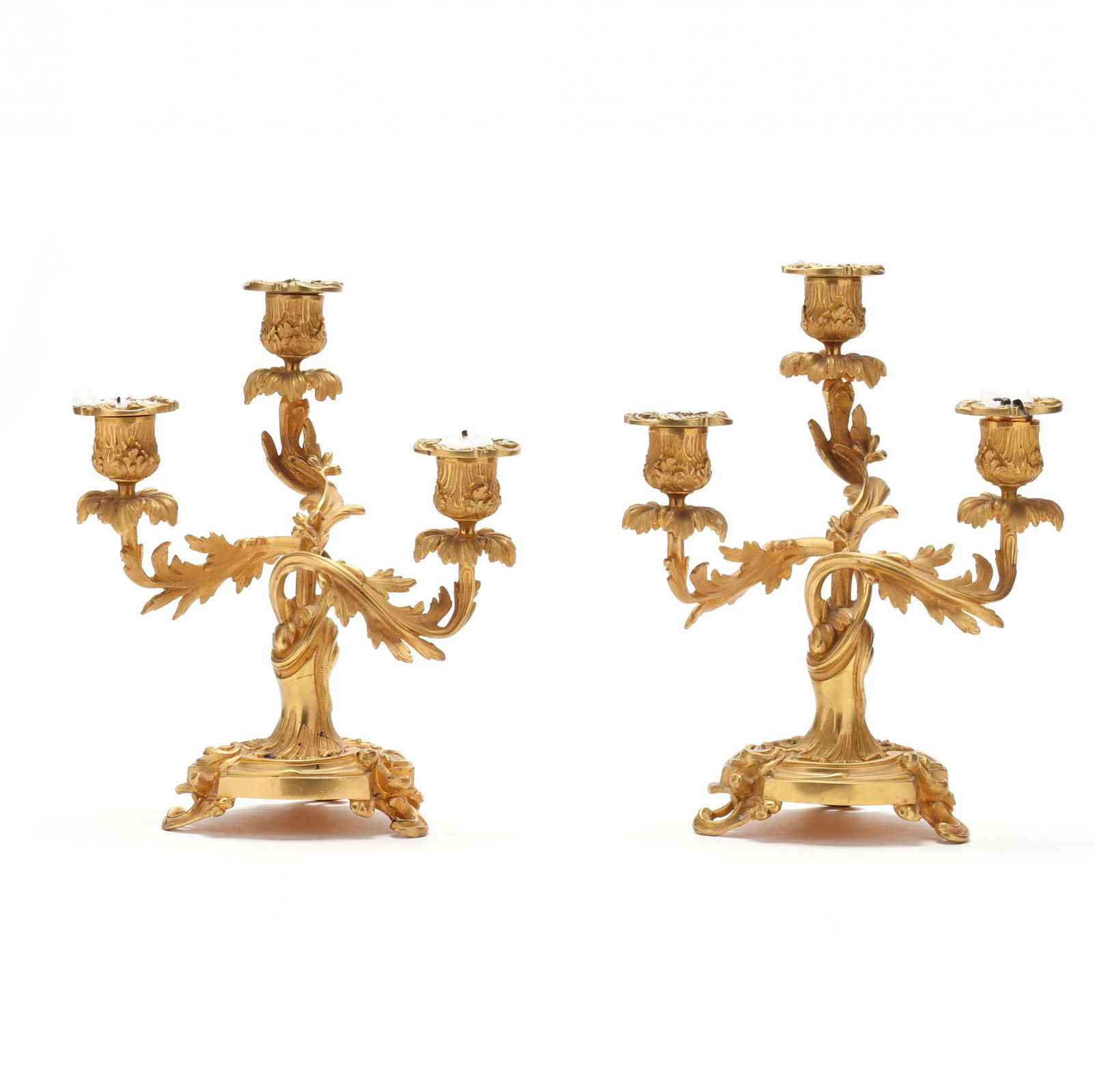 A Pair of Rococo Style Dore Bronze Three Light Candelabra: A Pair of Rococo Style Dore Bronze Three Light Candelabralate 19th century, swirling upswept acanthus branch arms, raised on a conforming rocaille base, unmarked. 10 3/4 x 8 1/4 x 6 in. From a Private