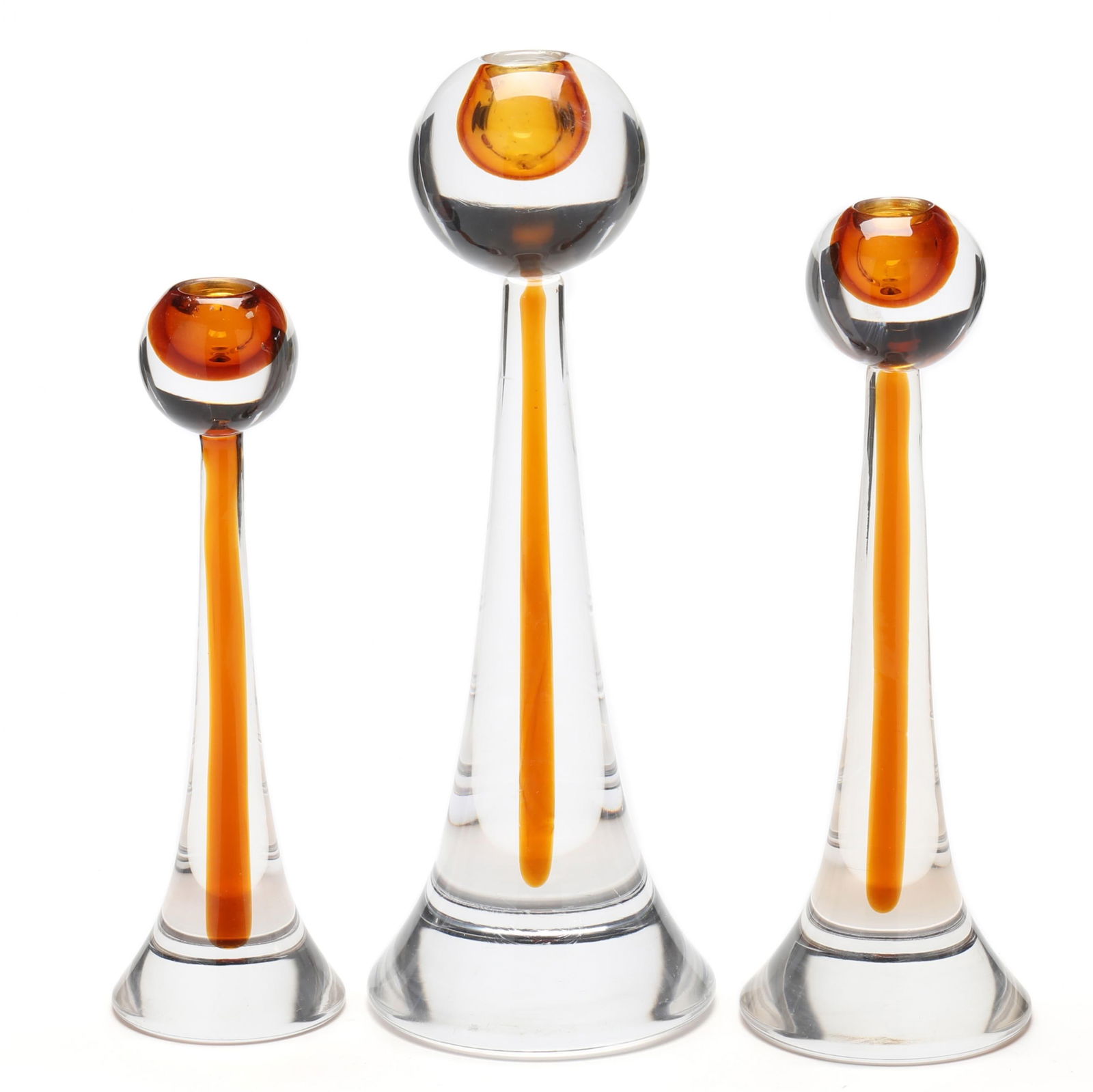 Gino Cenedese (Italy, 1907-1973), Three Graduated Glass Candlesticks: Gino Cenedese (Italy, 1907-1973), Three Graduated Glass CandlesticksMurano, second half 20th century, cased amber and clear glass with orb form candle holder and tapered support, unmarked. Tallest 14
