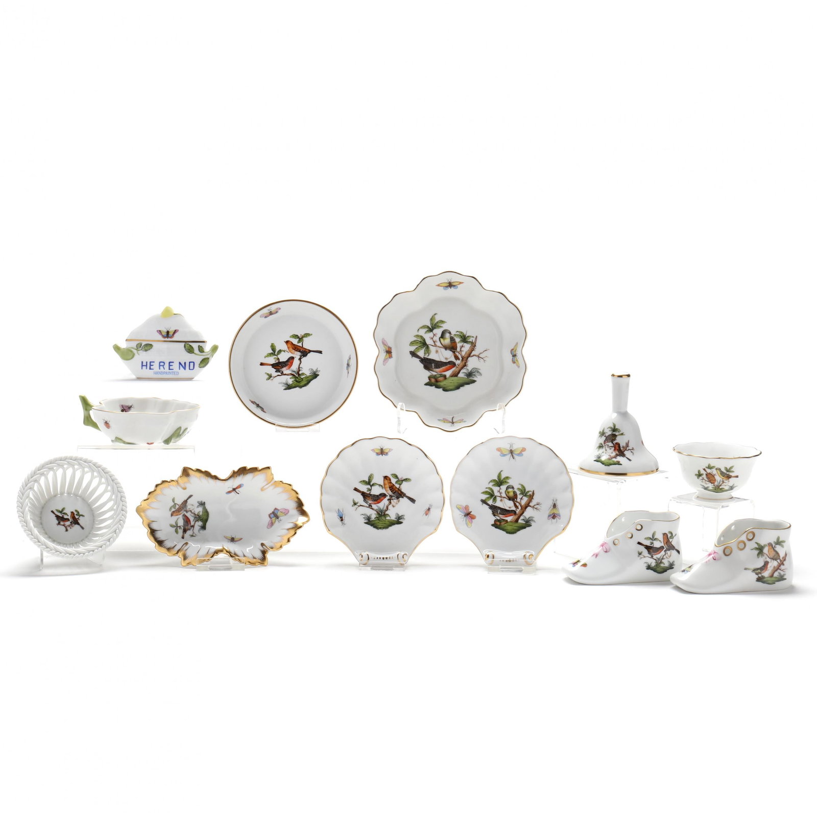 A Group of Twelve Herend Rothschild Bird Table Accessories: A Group of Twelve Herend Rothschild Bird Table AccessoriesHighlights of the group are a pair of shell dishes, a pair of booties, a bell and a reticulated small basket, included is a Herend trade sign,