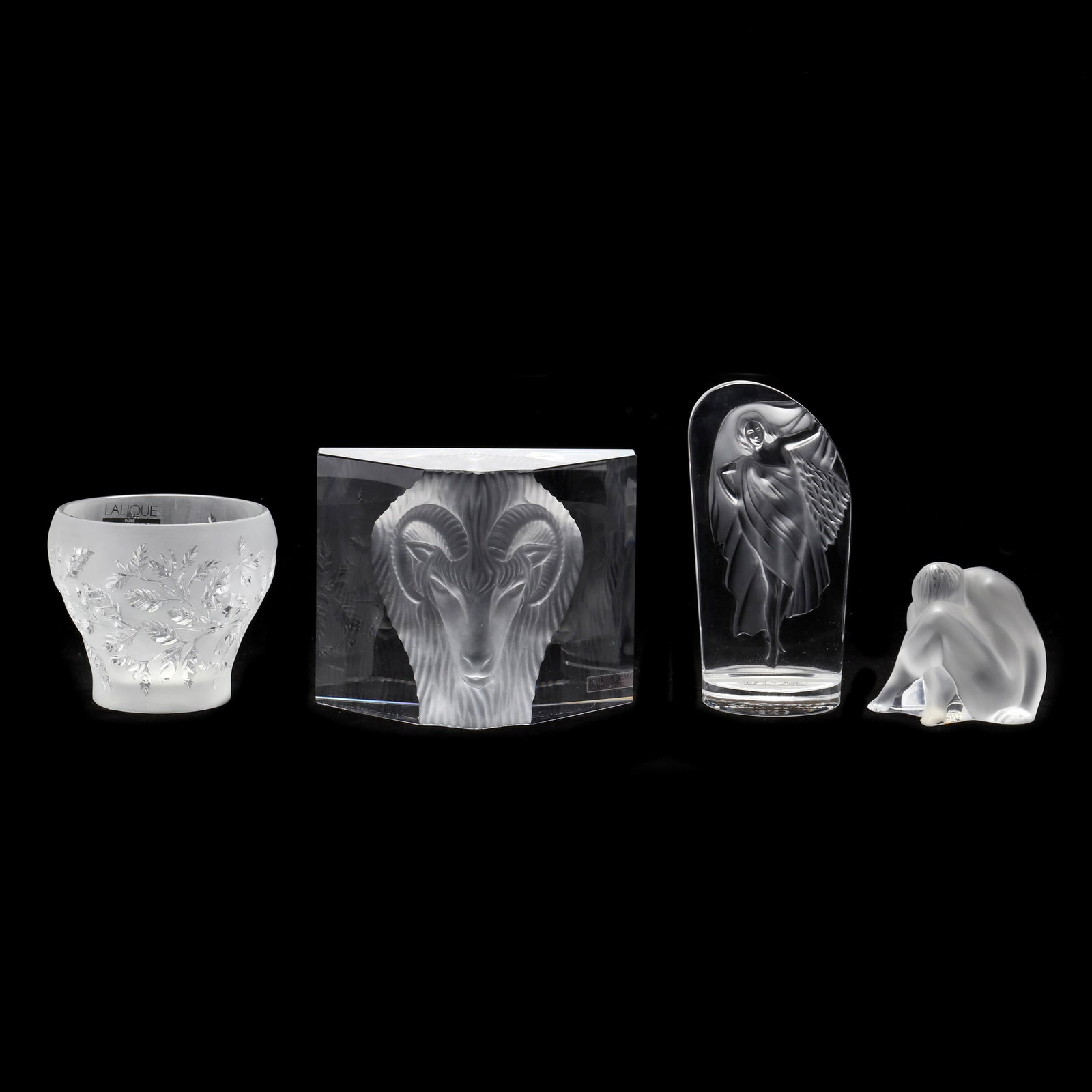 Three Pieces of Lalique Crystal and a Prism Sculpture: Three Pieces of Lalique Crystal and a Prism Sculpture including three contemporary frost crystal Lalique pieces: a miniature car mascot (5 in.), seated nude (2.5 in.), and a small vase with foliate mo