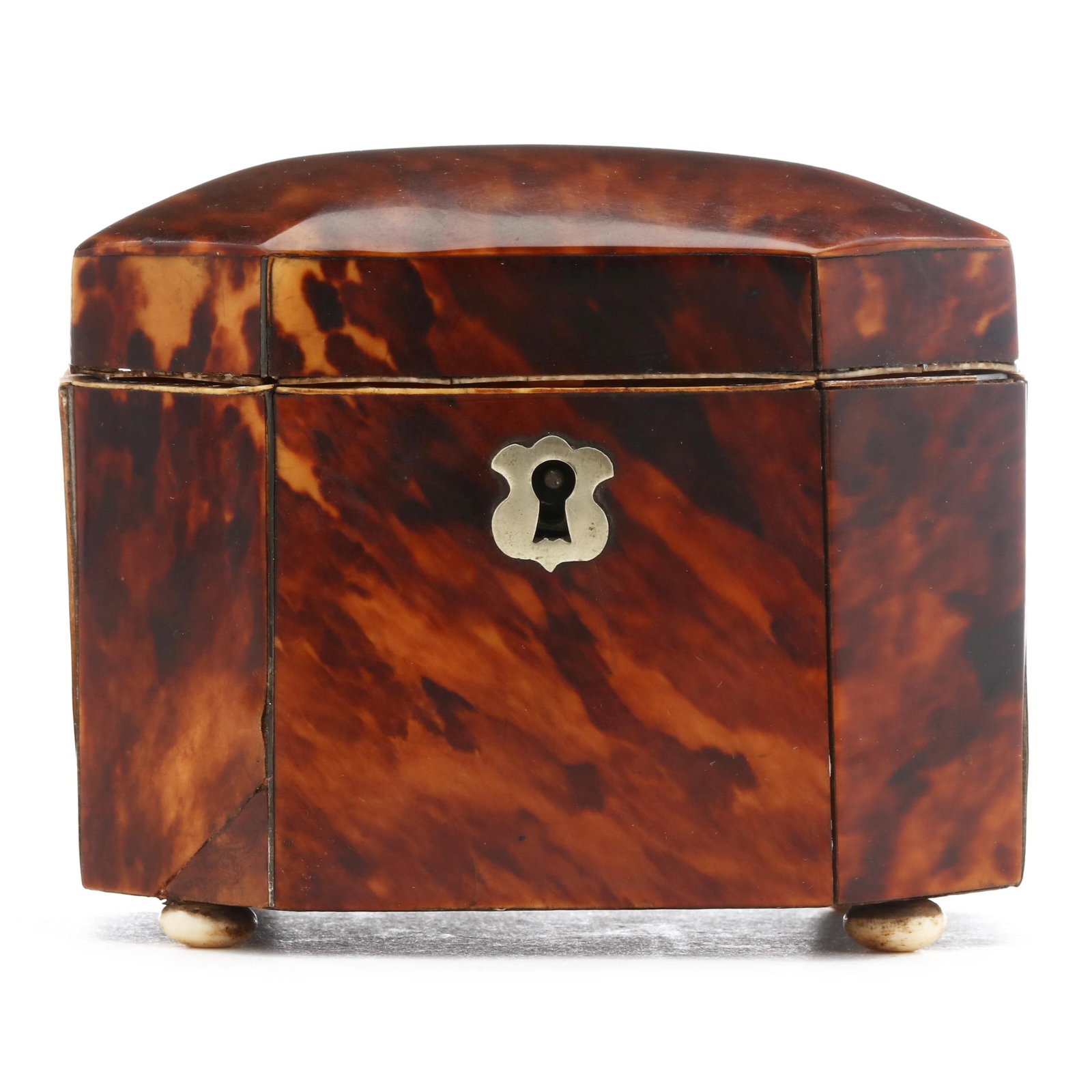 Regency Tortoiseshell Tea Caddy: Regency shell Tea Caddy early 19th century, shell and bone veneers with inlaid silver stringing, inlaid silver escutcheon, diminutive rectangular form with canted corners, interior with lidded single