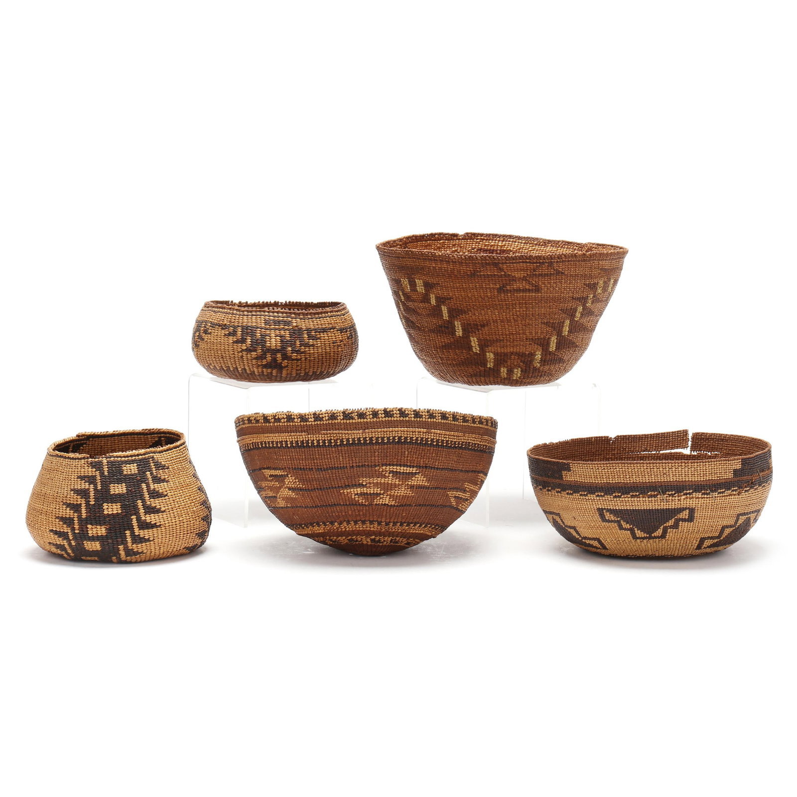 Five Antique Northern California Baskets: Five Antique Northern California Baskets to include: a Hupa /Yurok Hat Basket, early 20th century, tightly woven in a "stairway to heaven" pattern (4 x 7 1/4 in.); a squaw cap, possibly Modoc Indian, 