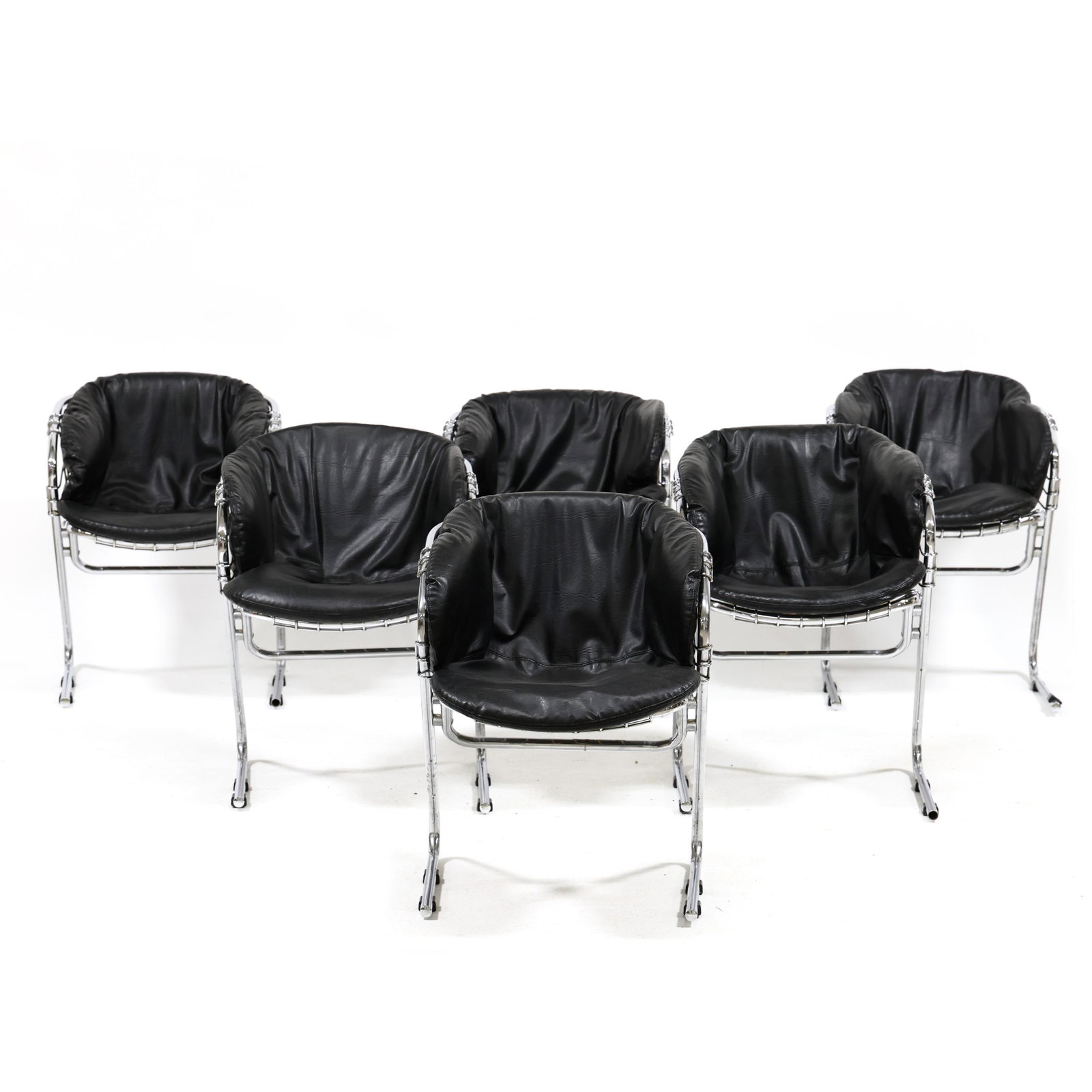 Gastone Rinaldi (Italian, 1920-2006), Six Chrome Cantilevered Dining Chairs: Gastone Rinaldi (Italian, 1920-2006), Six Chrome Cantilevered Dining Chairs1970s, for Selig, chrome plated steel frames with wire work bucket seats and vintage black faux leather cushions, black plast