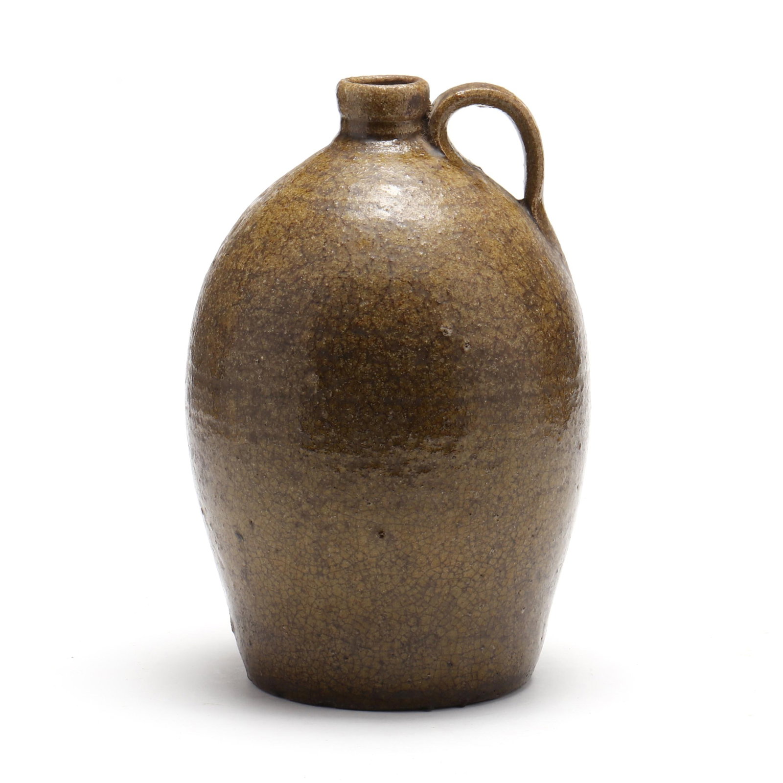 John Goodman (Cabarrus/Lincoln County NC, 1822-1907), One Gallon Jug: John Goodman (Cabarrus/Lincoln County NC, 1822-1907), One Gallon Juggreenish alkaline glaze with extensive crazing, tooled neck, applied slightly grooved handle, stamp "JG 1". 11 1/4 in. Single-Owner