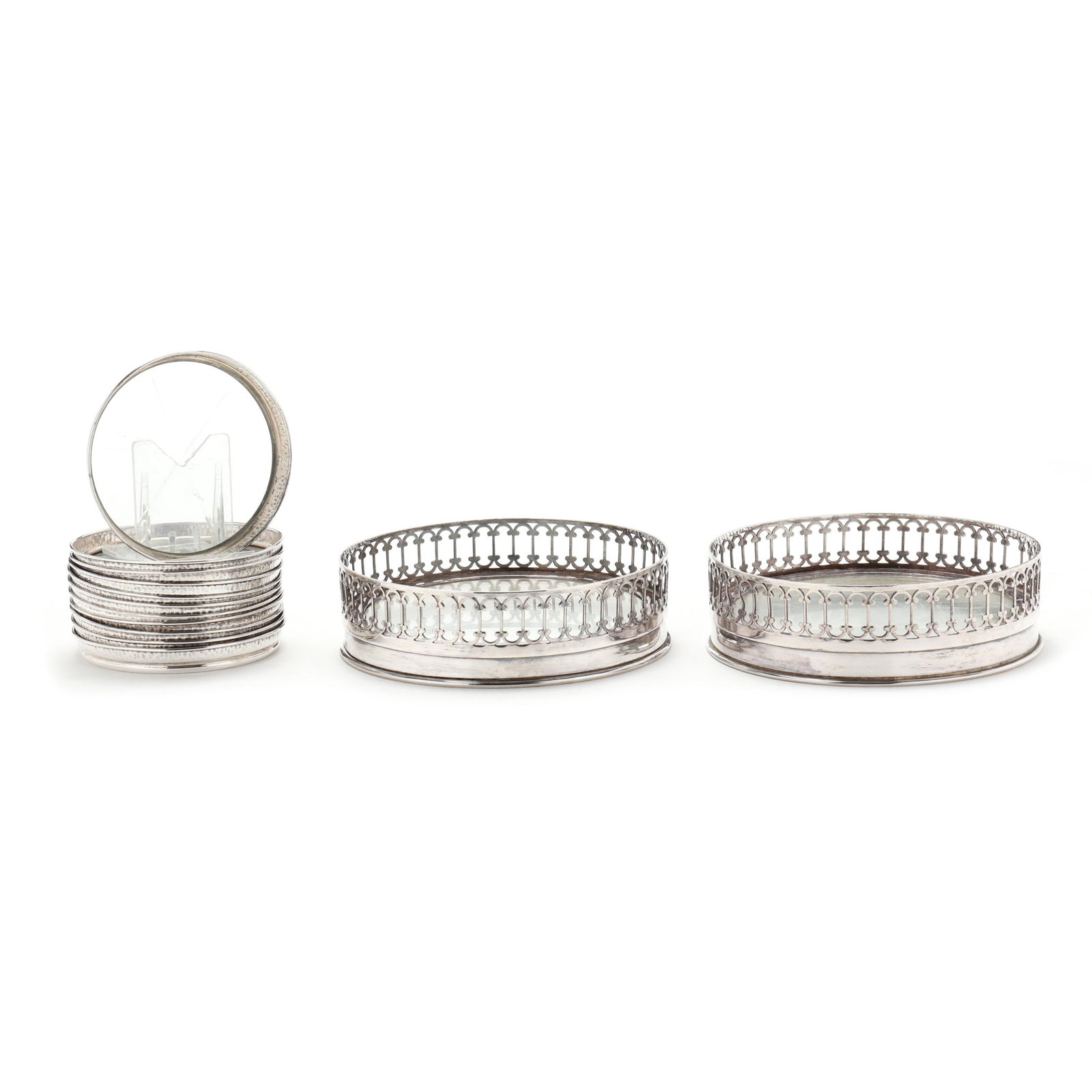 Collection of Sterling Silver and Silver-Plated Coasters: Collection of Sterling Silver and Silver-Plated Coastersincludes a set of (11) sterling silver drink coasters each having a cut glass insert and hammered exterior, illegible maker's marks, without mon
