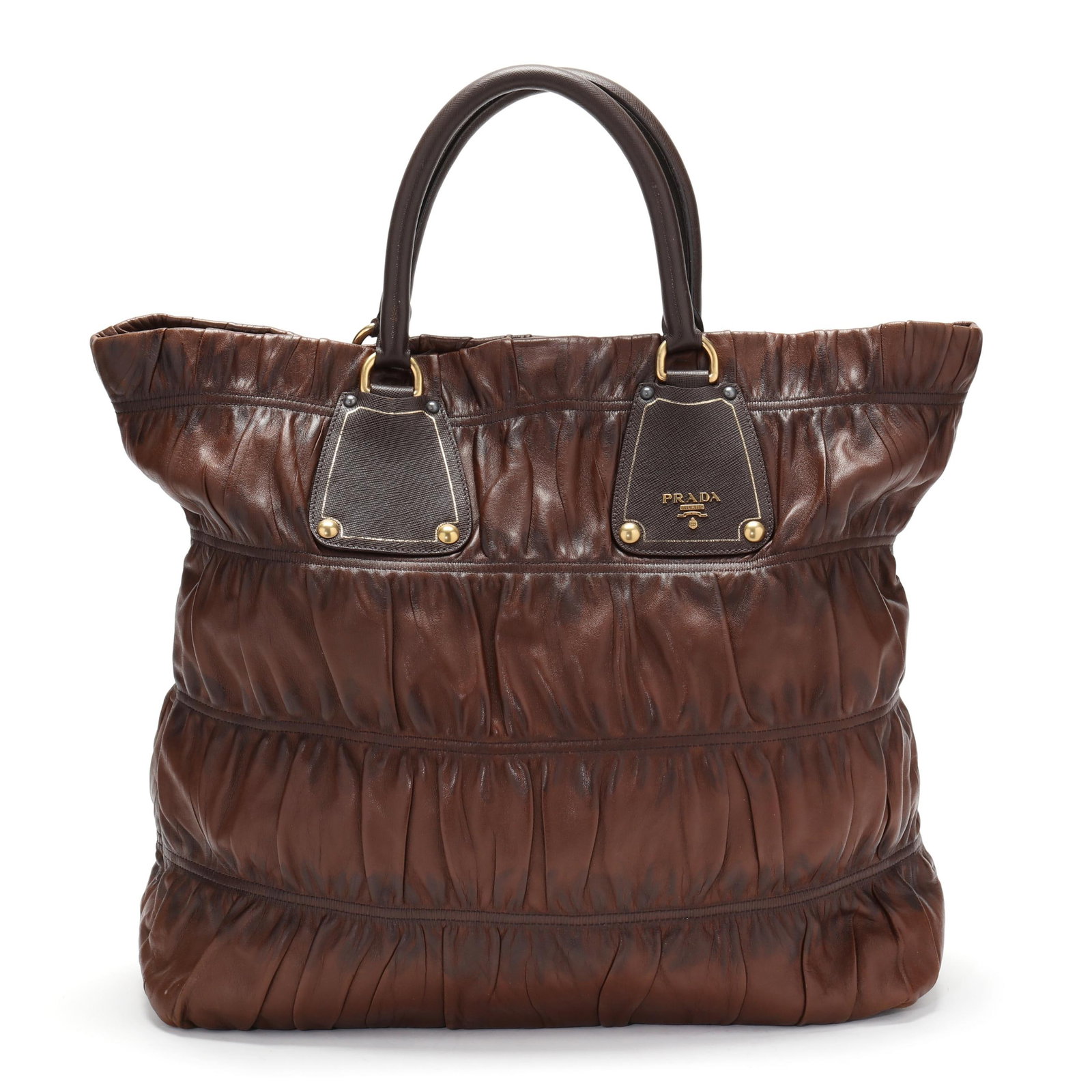 Prada Nappa Gaufre Shopping Satchel in Brown: Prada Nappa Gaufre Shopping Satchel in Brownmade in Italy and featuring gathered Napa leather in a warm chocolate brown with a darker brown dual rounded leather handles. A magnetic snap closure opens