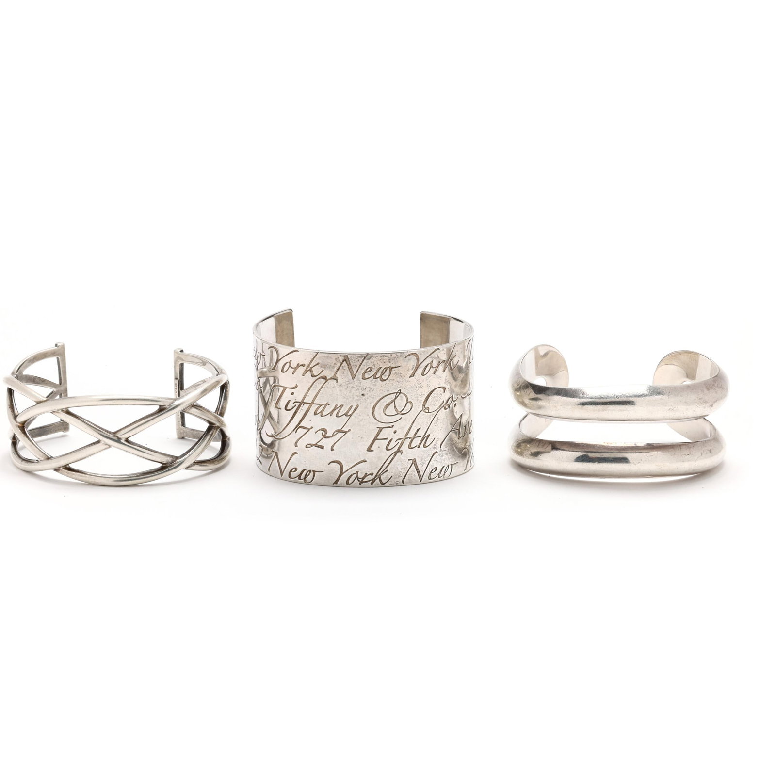 Two Sterling Silver Cuff Bracelets, Tiffany & Co. and a Sterling Silver Cuff Bracelet, Elsa Peretti: Two Sterling Silver Cuff Bracelets, Tiffany & Co. and a Sterling Silver Cuff Bracelet, Elsa Peretti for Tiffany & Co.to include: a Celtic knot cuff bracelet, stamped T & Co. / 925 / Italy (27 mm x 6.5