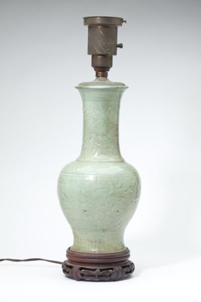 Chinese Celadon Vase Table Lamp: Chinese Celadon Vase Table Lamp possibly Qianlong, allover crackle surface with subtle carved design, set into early mahogany plinth and bronze lamp socket. HOA 24 in.; vase 15 in. Private Collection,