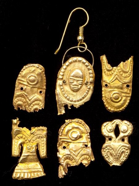 Six Pre-Columbian Gold Plaquettes: Six Pre-Columbian Gold Plaquettes Muisca style, Colombia, circa 800 - 1500 A. D., repousse sheet gold fragments, one of a bird's body, (4) with birds' heads and one fashioned as a human mask. .75 - 1 
