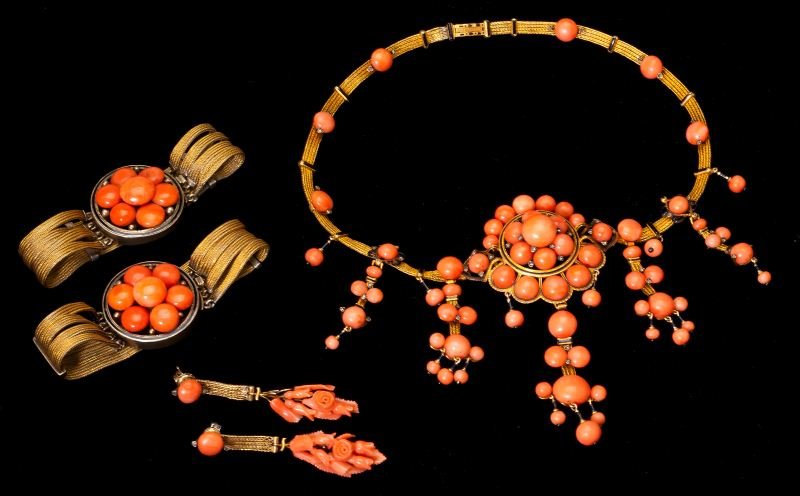 French Antique Coral Suite: French Antique Coral Suiteconsisting of a choker necklace centered with an elaborate mounting of graduated cabochon and bead cut salmon coral beads suspending coral girandole drops and with coral bead