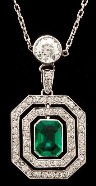 Platinum, Emerald and Diamond Pendant Necklace: Platinum, Emerald and Diamond Pendant NecklaceArt Deco Period, centering on one octagonal cut emerald gemstone (6.50 x 5.90 x 3.60 mm) (.94 carat) and F1 enhancement bezel set in a platinum frame and