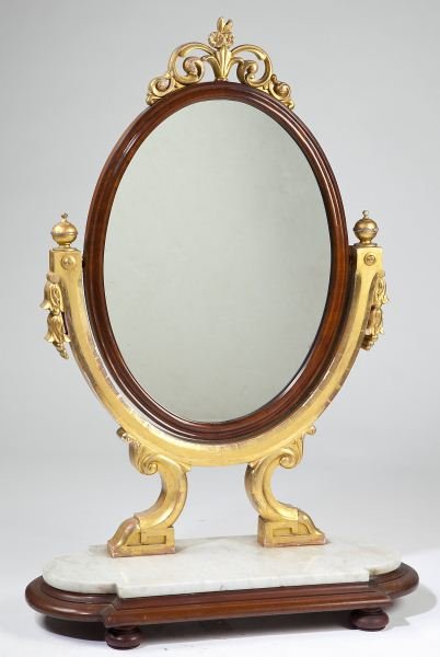 Continental Table Top Dressing Mirror: Continental Table Top Dressing Mirror mid-19th century, probably French, oval form mahogany veneered frame houses a swivel glass, the frame decorated with parcel gilt floral cluster to the crest, shap