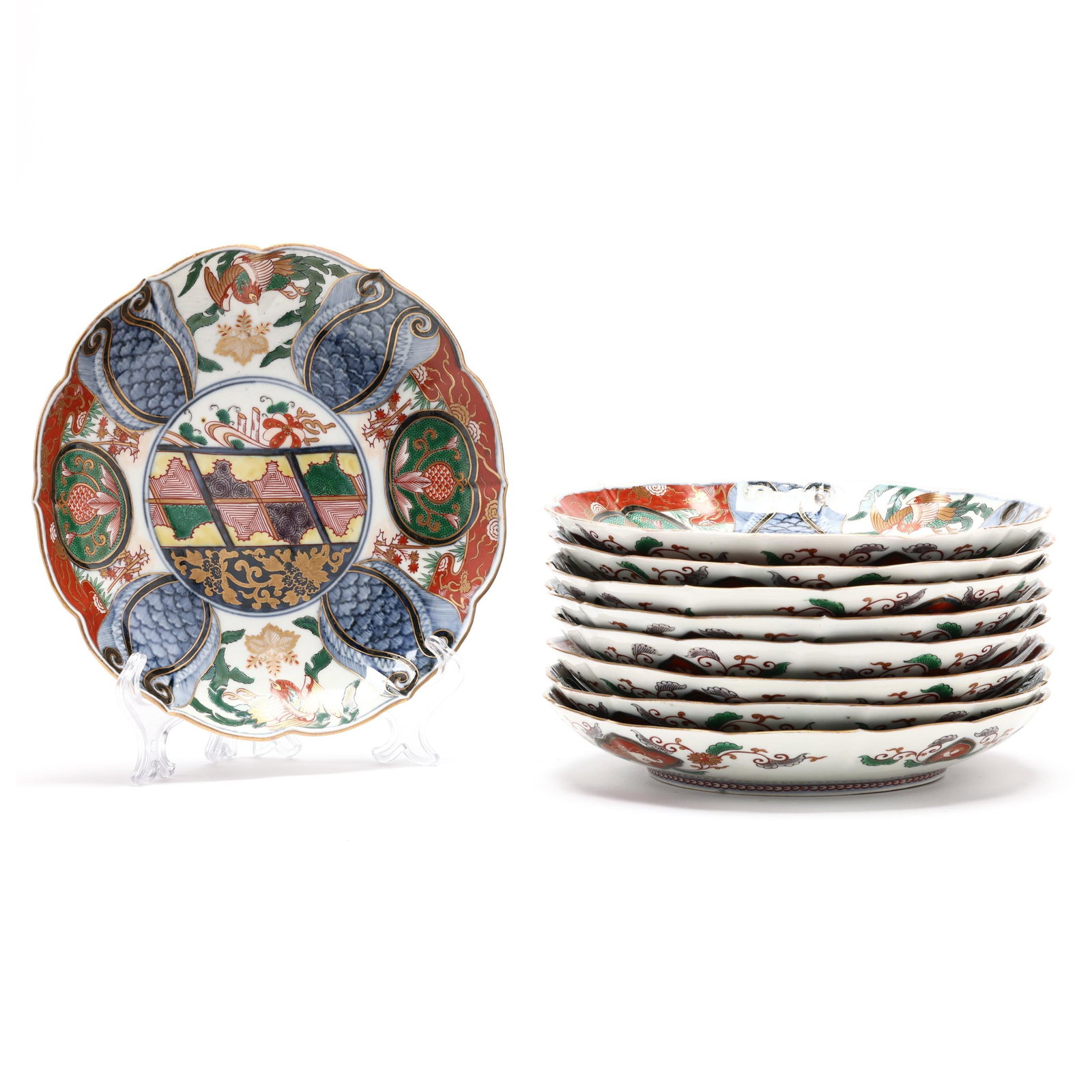 A Set of Nine Porcelain Imari Dinner Plates: A Set of Nine Porcelain Imari Dinner Plates late 20th century, barbed style rim, each porcelain dish is decorated in a similar manner with jeweled colors, a six character apocryphal Wanli mark to unde