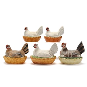 A Group of Four Bisque Porcelain Hens on Nests