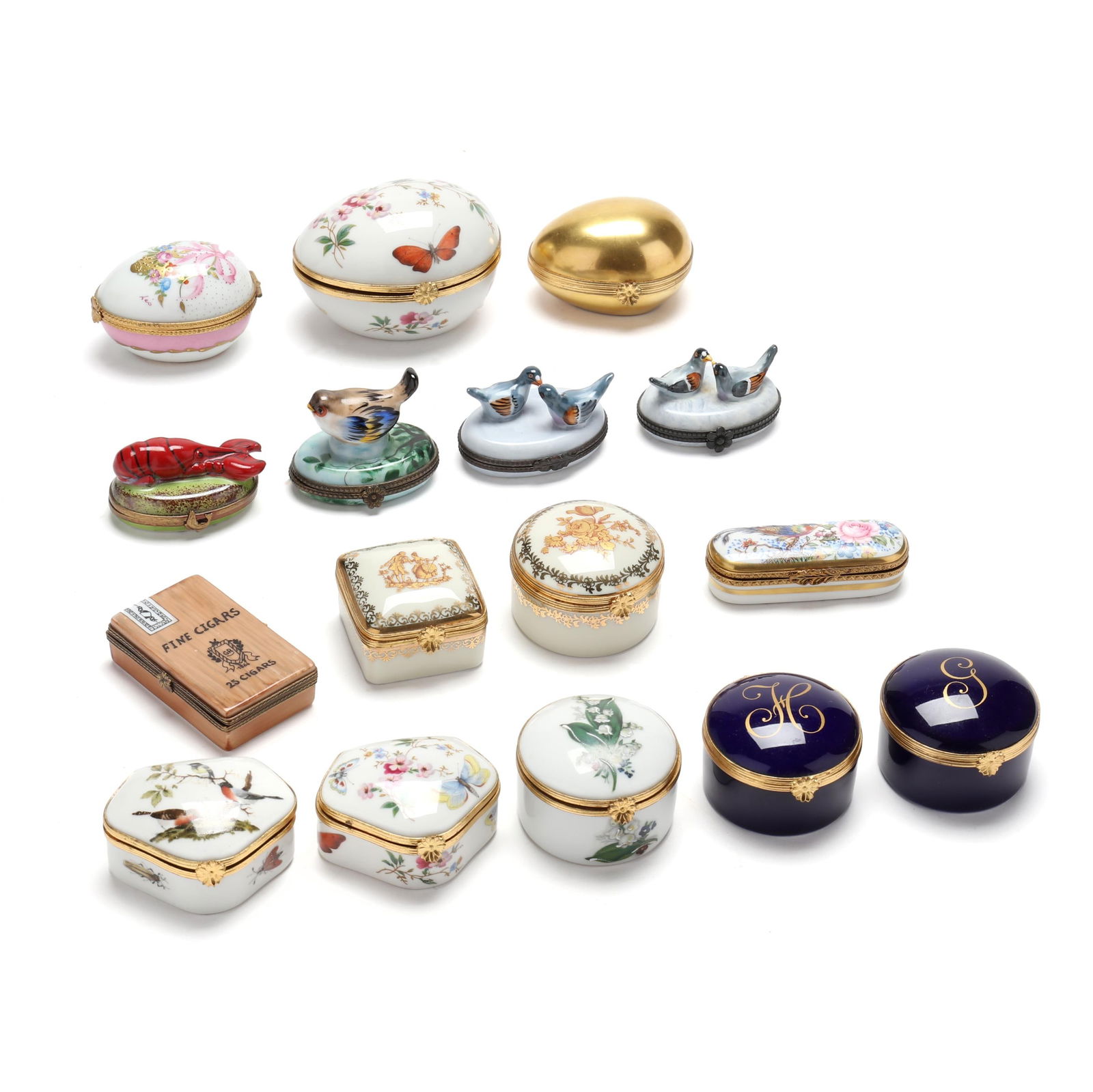 A Collection Of Sixteen Limoges Porcelain Pill Boxes: A Collection Of Sixteen Limoges Porcelain Pill Boxes20th century, four (4) with an avian motif, three are egg shaped, a rectangular box holding cigars has break (piece is present), (9) others. Large e