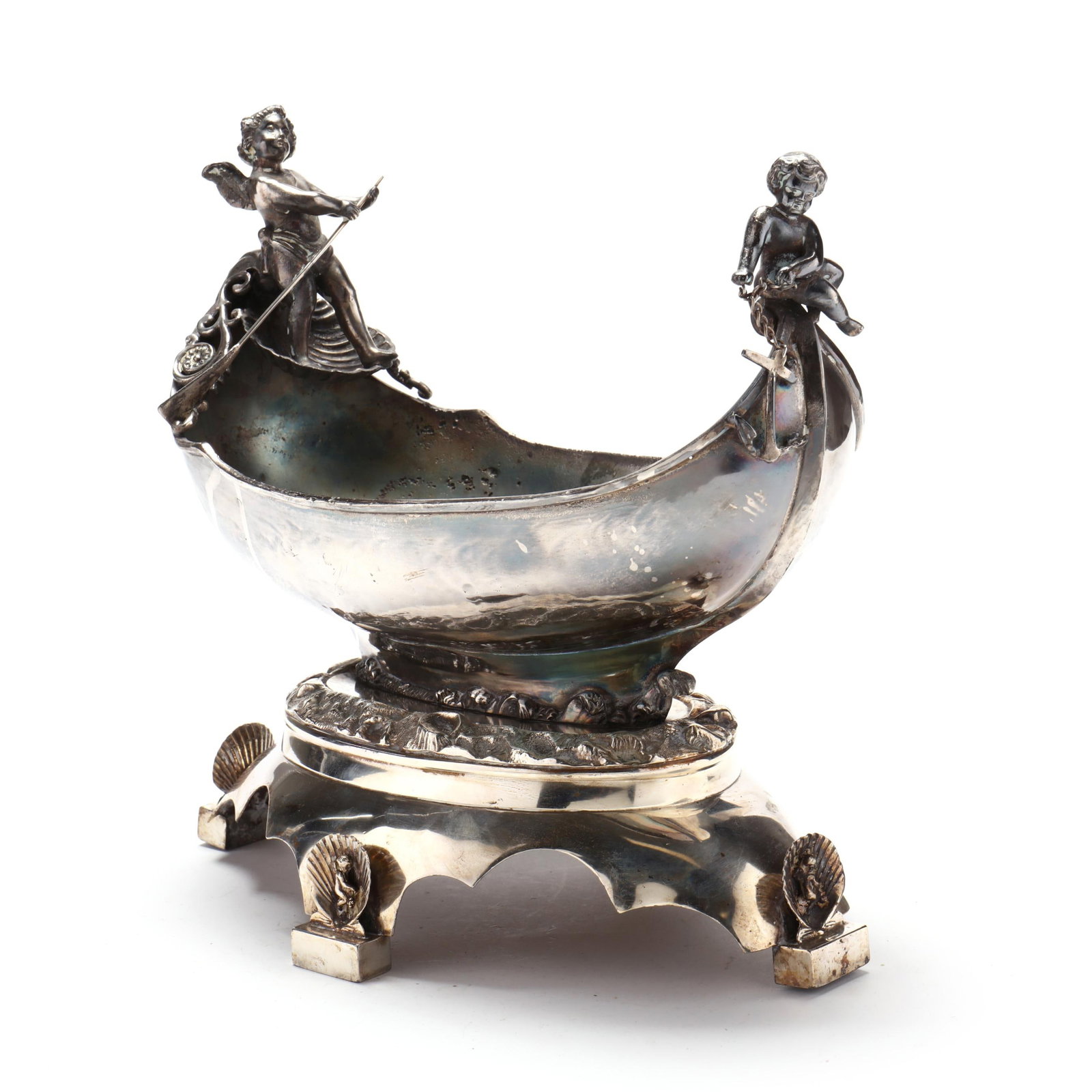 A Silver-Plated Figural Centerpiece Bowl: A Silver-Plated Figural Centerpiece Bowllate 19th century, mark reading "George Sharp", pattern number 967, in the form of a gondola guided by two cherubs on conforming stylized pedestal base with fou