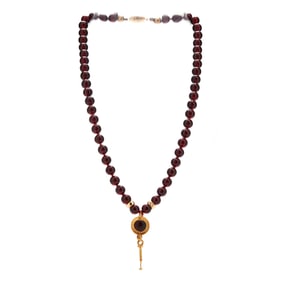 Ancient Roman Gold Earring on a Modern Garnet Necklace