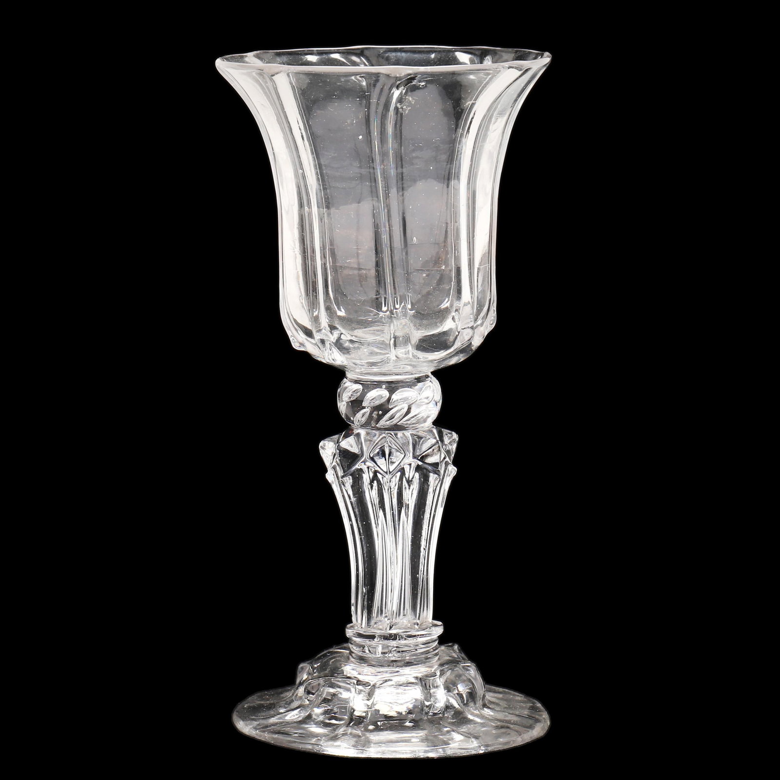 Georgian Tooled Glass Wine Goblet: Georgian Tooled Glass Wine Goblet circa 1720, mold blown and tooled clear glass with inverted bell raised spiral rib cup over an air trap disc, shaped molded stem, conical foot with repeating ribbed m