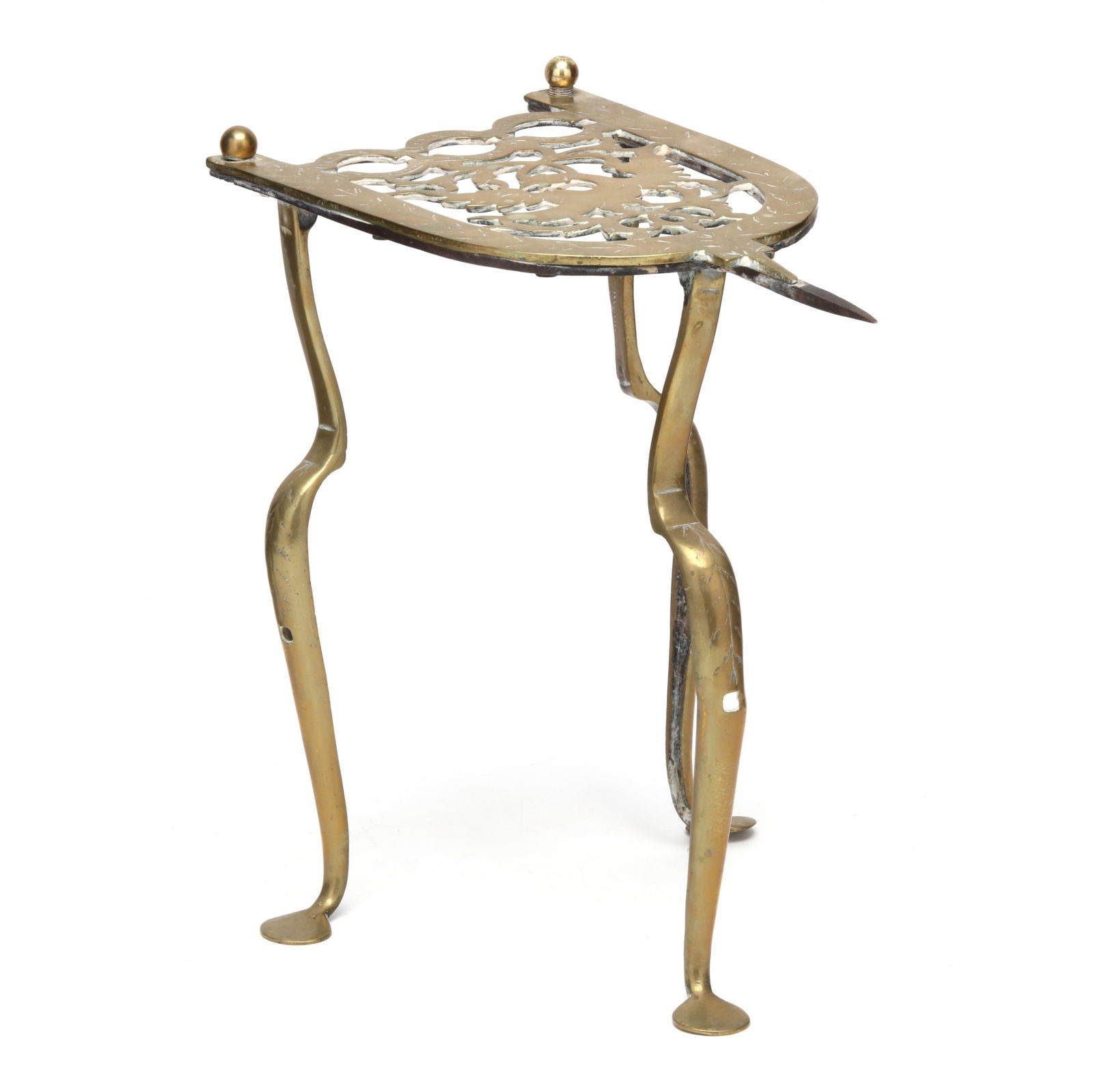 Queen Anne Brass Hearth Trivet: Queen Anne Brass Hearth TrivetEngland, mid-18th century, arched plate featuring an openwork phoenix, top and knees engraved with repeating foliate motif, raised on three cabriole legs with pad foot, u