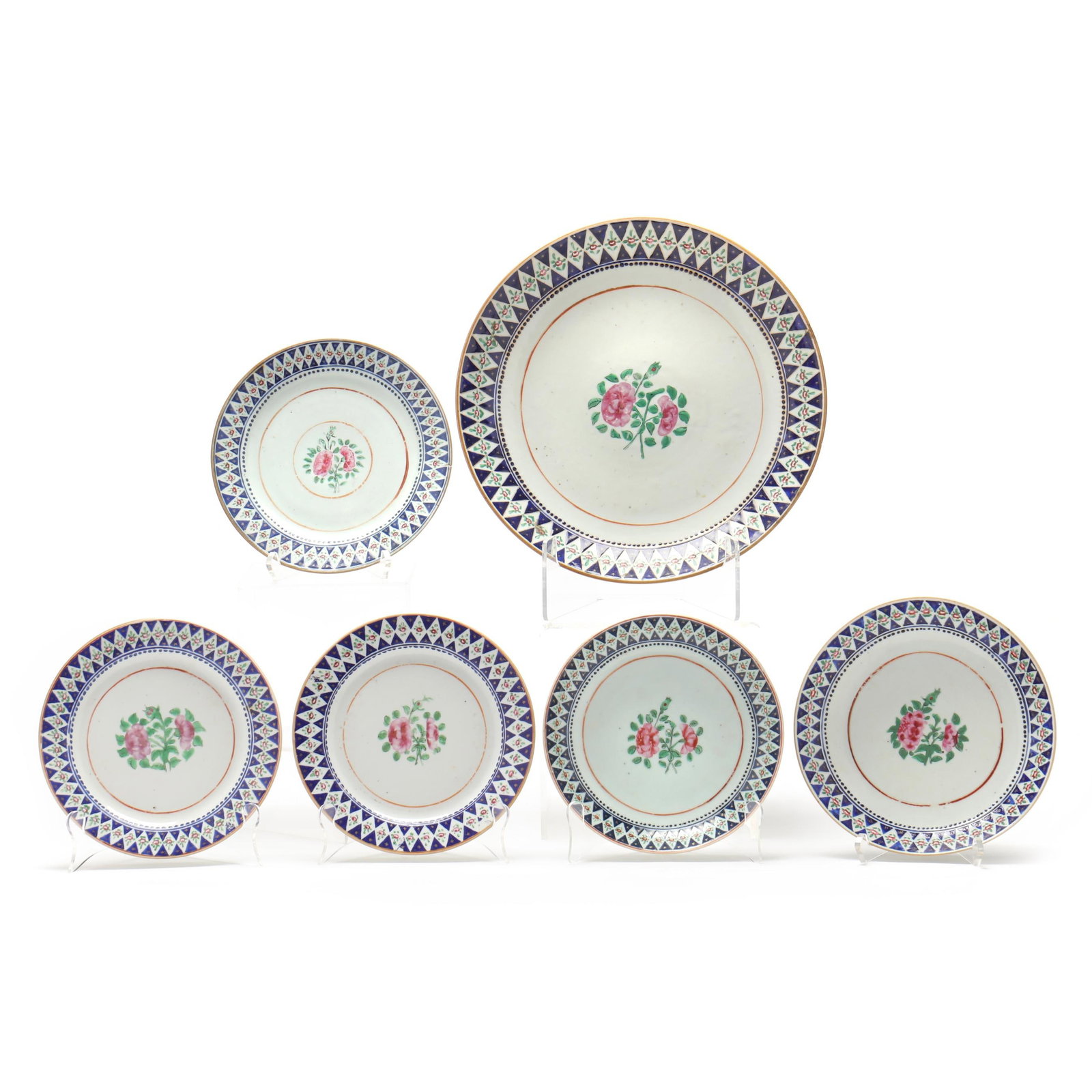 Set of Chinese Export Porcelain Famille Rose Plates: Set of Chinese Export Porcelain Famille Rose Plates mid 19th century, hand painted with a blue and white overglaze diamond pattern to the rim, floral and gilt star embellishments featured within the d