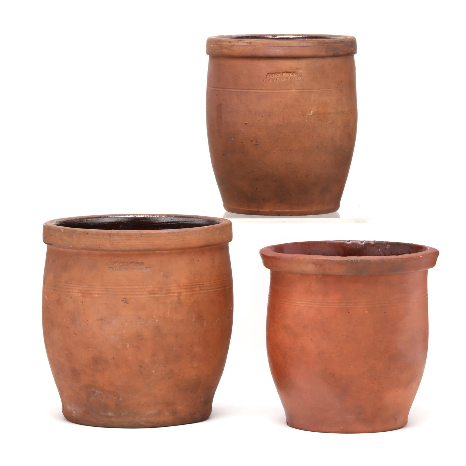 Three Vintage Pennsylvania Redware Pots: Three Vintage Pennsylvania Redware Potsthe first, stamped "V. RUDOLPH," Shippensburg, PA, circa 1868-1888, tapered pot with unglazed exterior, clear lead glazed exterior, impressed on underside with V