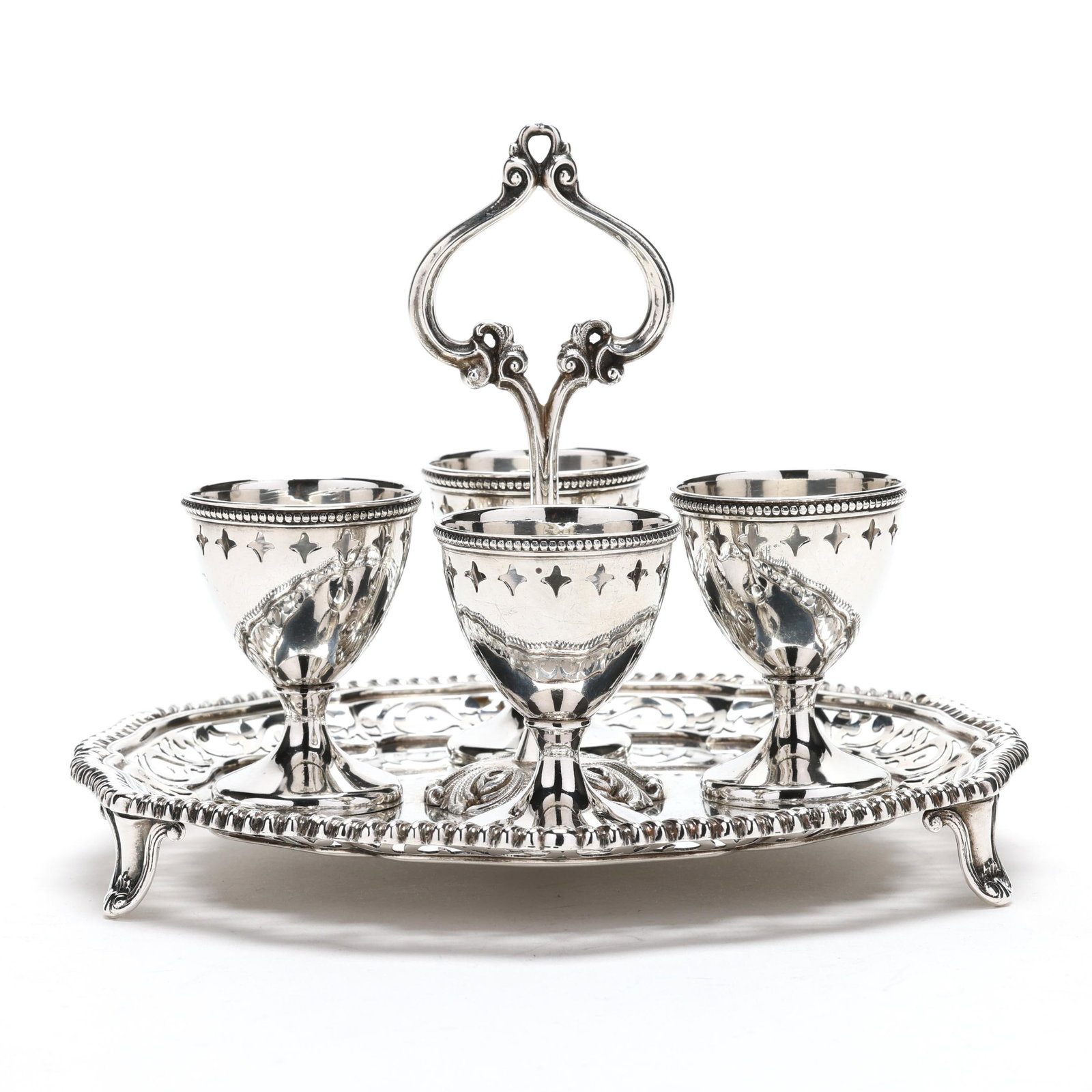 A Rare American Sterling Silver Egg Cruet: A Rare American Sterling Silver Egg Cruetretailed by F. Walter Lawrence in Chicago, manufactured by Dominick & Haff in 1911, the circular tray raised on three bracket feet and featured a gadrooned edg