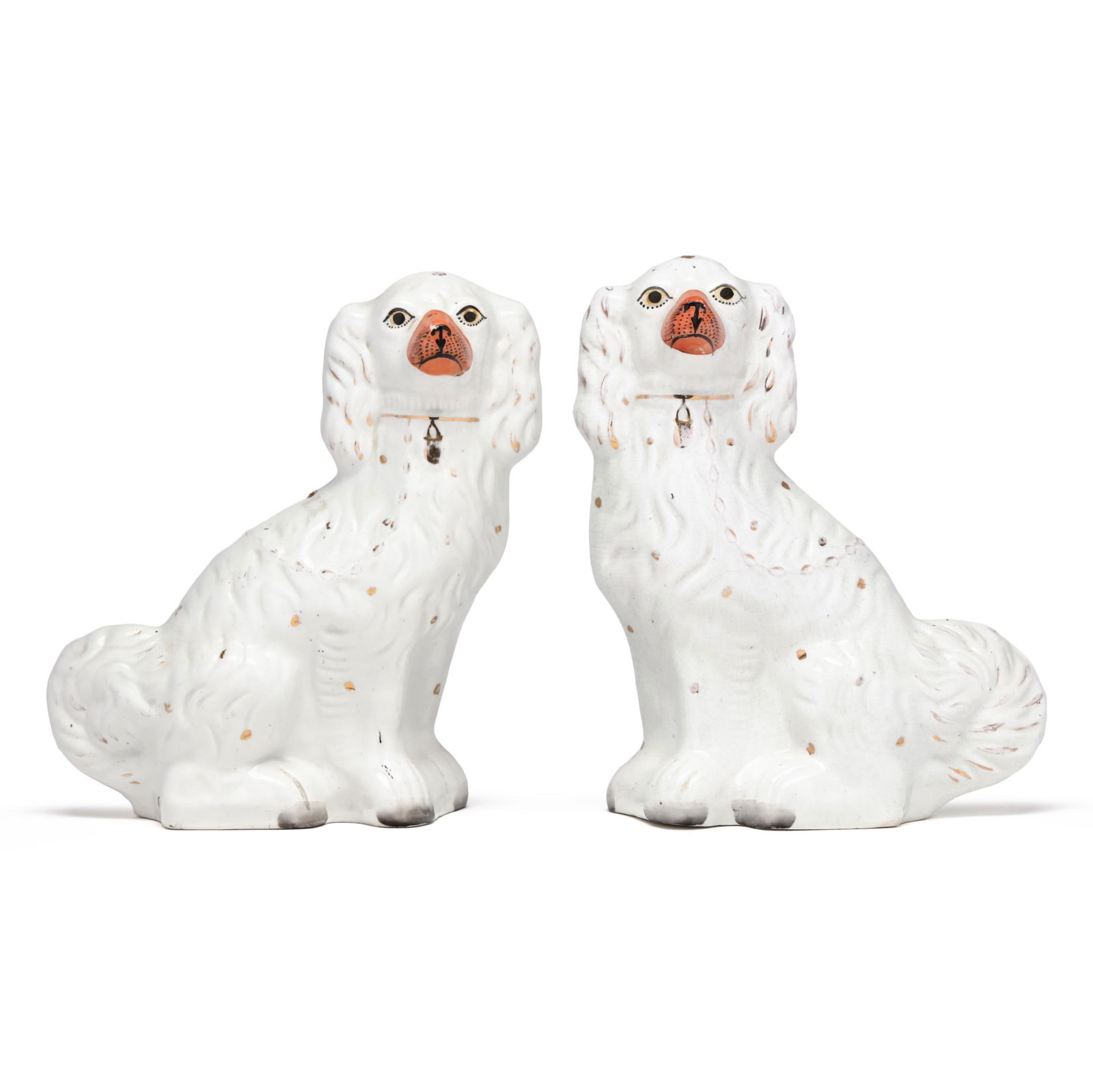 Large Pair of Facing Staffordshire Spaniels: Large Pair of Facing Staffordshire SpanielsEngland, third quarter 19th century, molded earthenware spaniels in white with hand-painted and gilt details, unmarked. 12 1/2 x 9 1/2 x 5 in. Private Collec