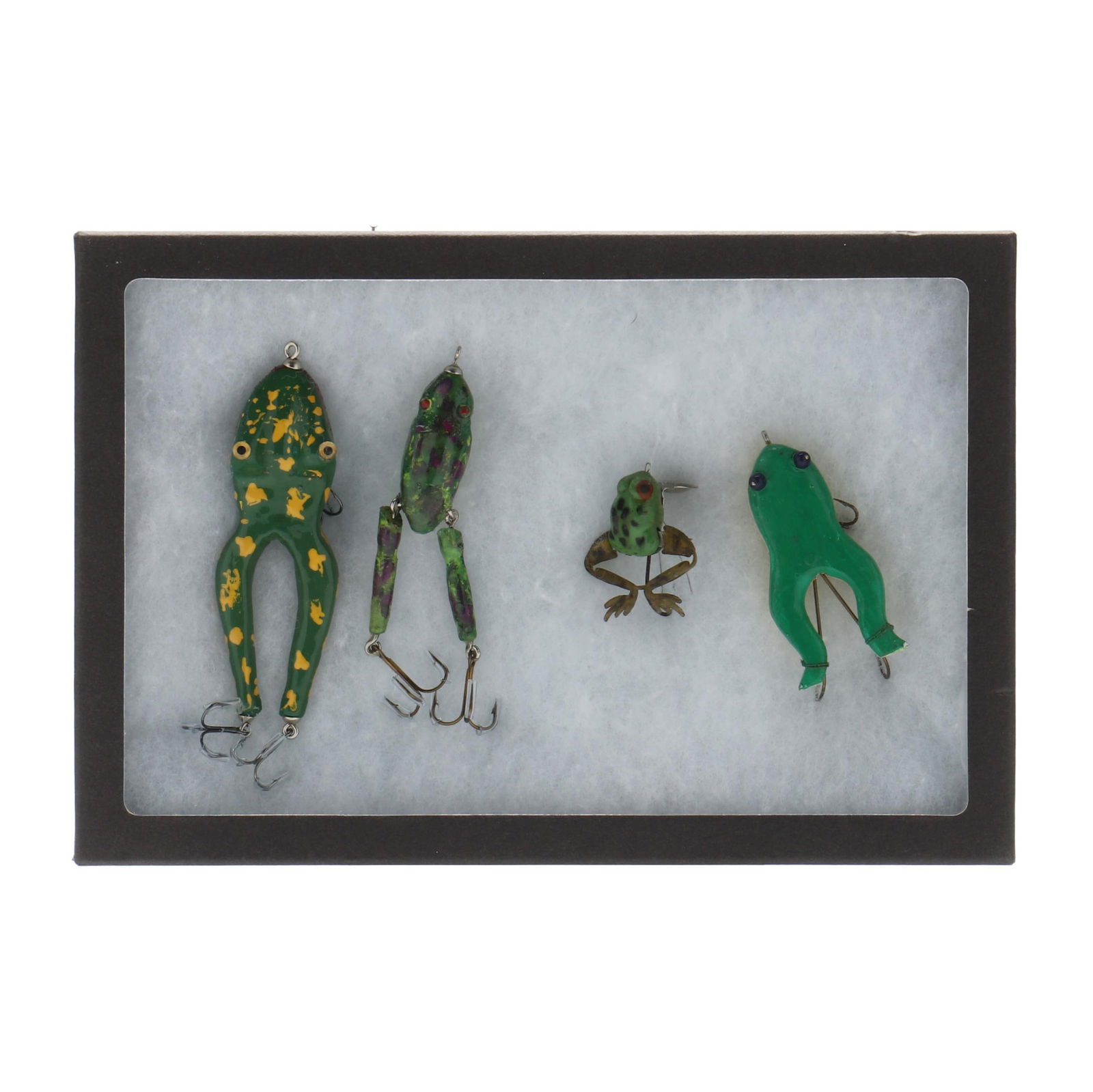 Four Frog Lures in Display Box: Four Frog Lures in Display Boxmid 20th century Jensen Midget Kicker has plastic body, rubber articulated legs and metal hardware, three hand carved wooden reproduction frog lures, one signed H. REINHE