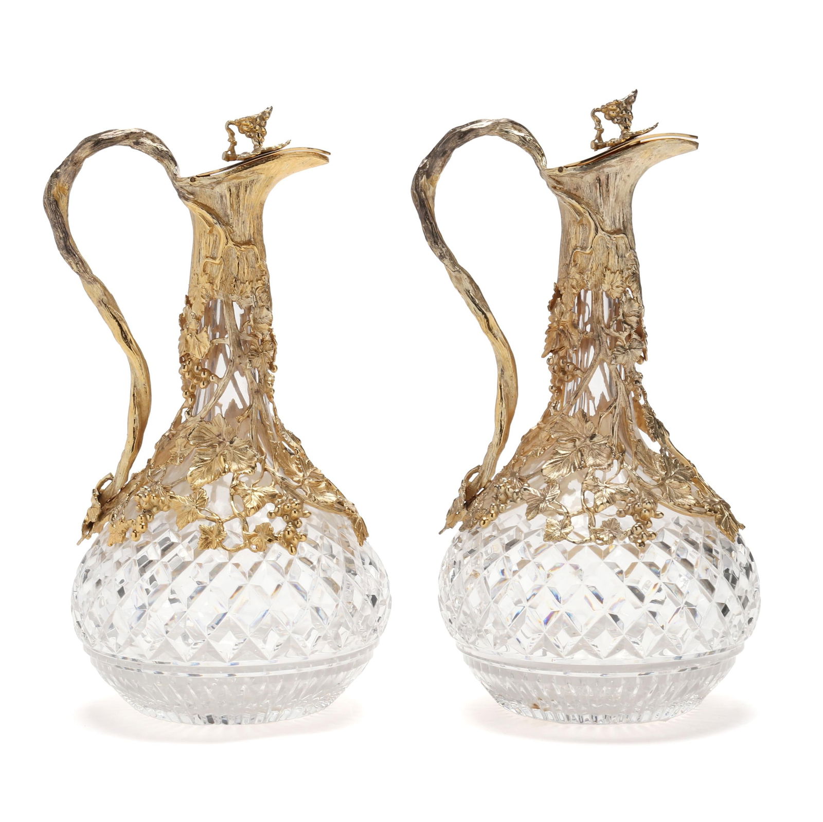 A Pair of English Crystal Claret Jugs with Gilt Silver-Plated Mounts: A Pair of English Crystal Claret Jugs with Gilt Silver-Plated Mounts20th century, mark of David Shaw Silverware Ltd., the cut crystal claret jug marked for Royal Doulton, with naturalistic grape and v