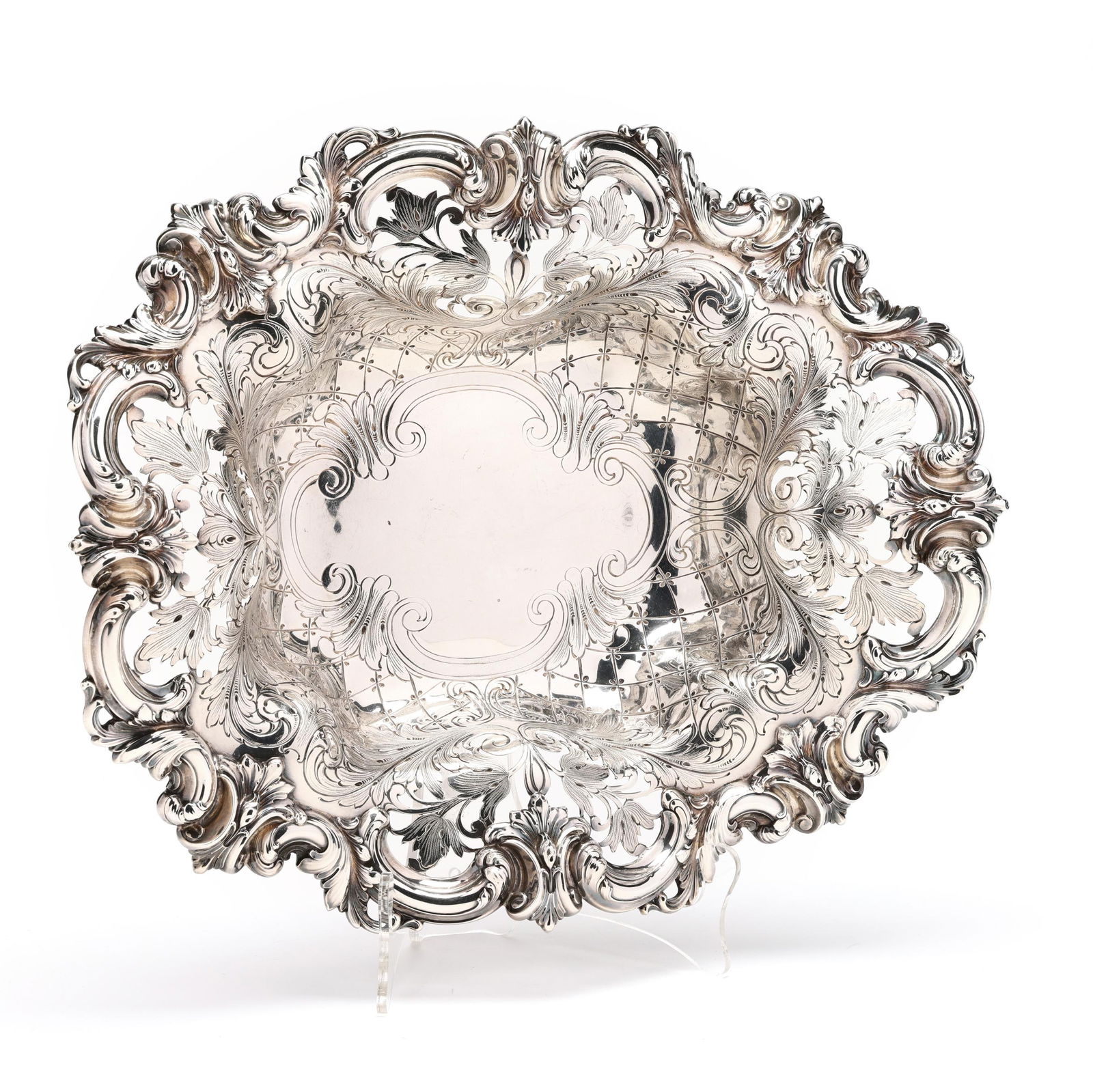 A Large Frank Smith Sterling Silver Centerpiece Basket: A Large Frank Smith Sterling Silver Centerpiece Basketpattern number 2042, with a cartouche form well, crosshatched border, and openwork rocailles foliate rim, not monogrammed. 3 5/8 x 15 x 12 in. 30.