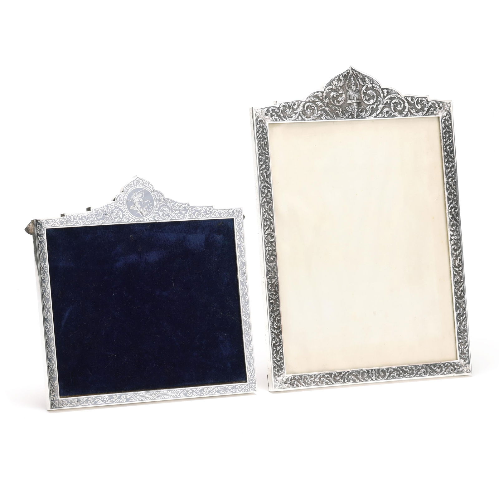 Two Thai Sterling Silver Picture Frames: Two Thai Sterling Silver Picture Frameseach marked "Hanakan / Sterling / Thailand", one in a vertical format featuring a repousse arched pediment with a Bhodissatva, mounted with a wood backing; the o