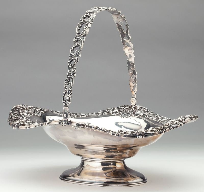 American Sterling Silver Cake Basket: American Sterling Silver Cake Basket circa 1900, by Black, Starr, & Frost; numbered B2173, oval form raised on a conforming foot with large swing handle, the rim and handle reticulated and with elabor