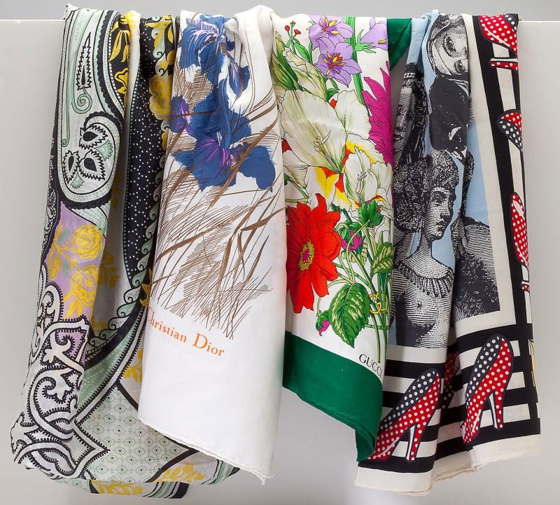 A Group of Four Designer Silk Scarves: A Group of Four Designer Silk Scarvesthe first by Christian Dior, white with Iris print (29.5 x 30.5 in.) no tag; an Etro made in Italy wrap (64.5 x 26 in.) with tags; the third a Moschino Italy creat