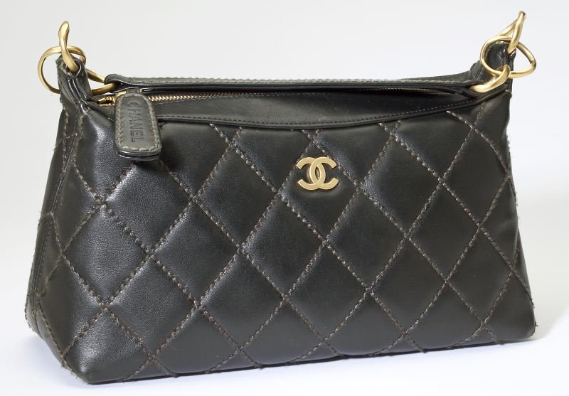 A Quilted Leather Handbag, Chanel: A Quilted Leather Handbag, Chanel1990s, designed as a simple rectangular bag of quilted black leather with exaggerated grey stitching throughout and brushed gold hardware, one side having the intertwi