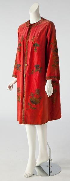 French Antique Beaded Coat: French Antique Beaded Coatof salmon toned velvet with beaded and stylized flowers symmetrically placed to front panels, front closure with two gold-toned pierced buttons, which may be later. Sleeve 22
